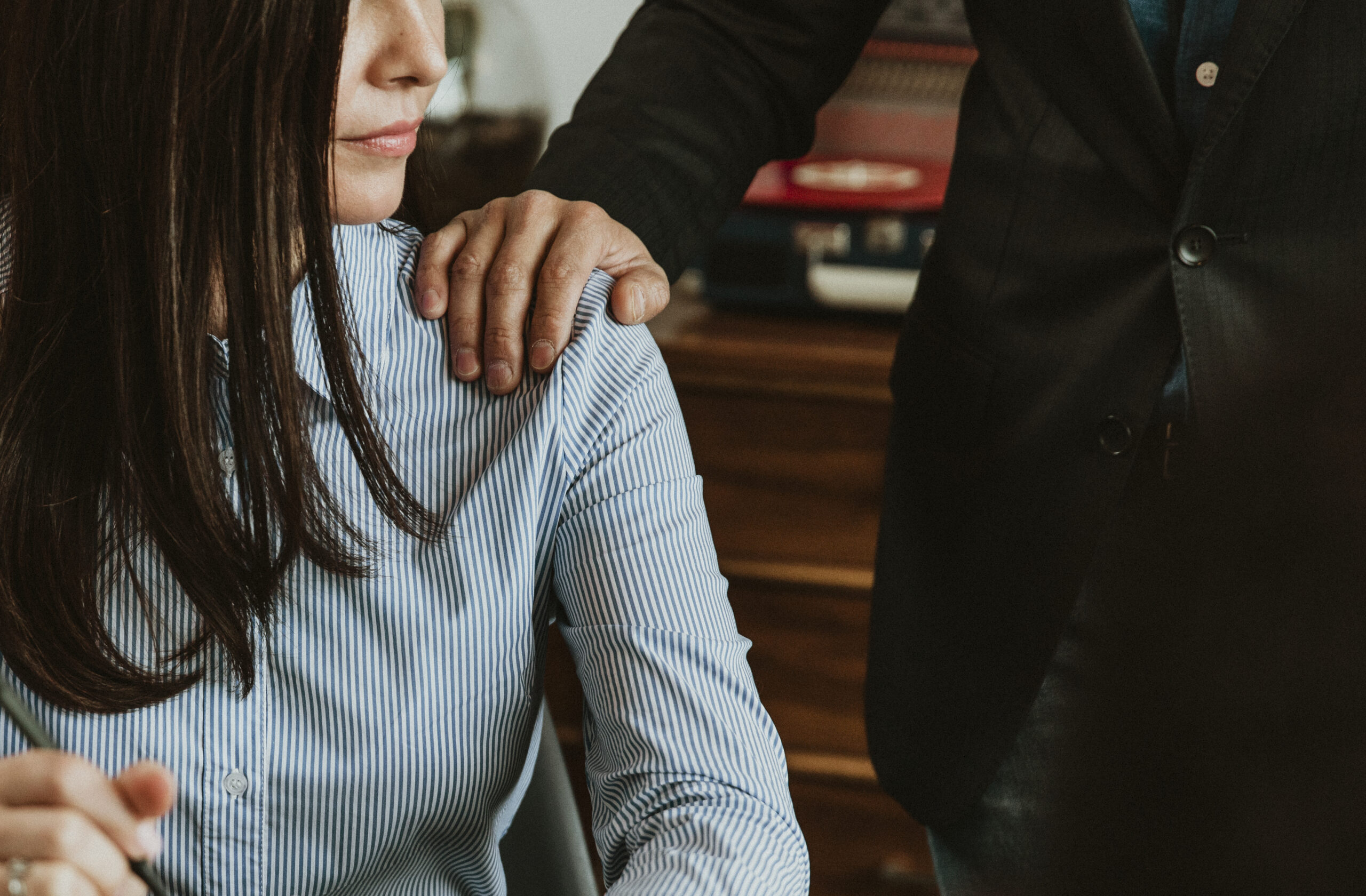 Businessman patting a colleague on her shoulder